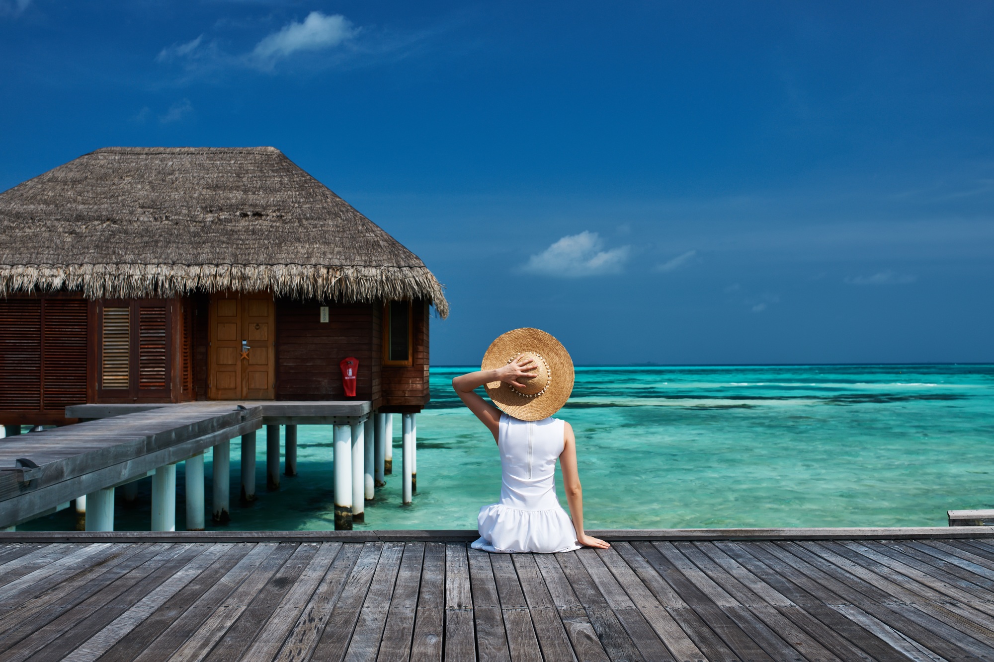 Woman on a beach jetty at Maldives